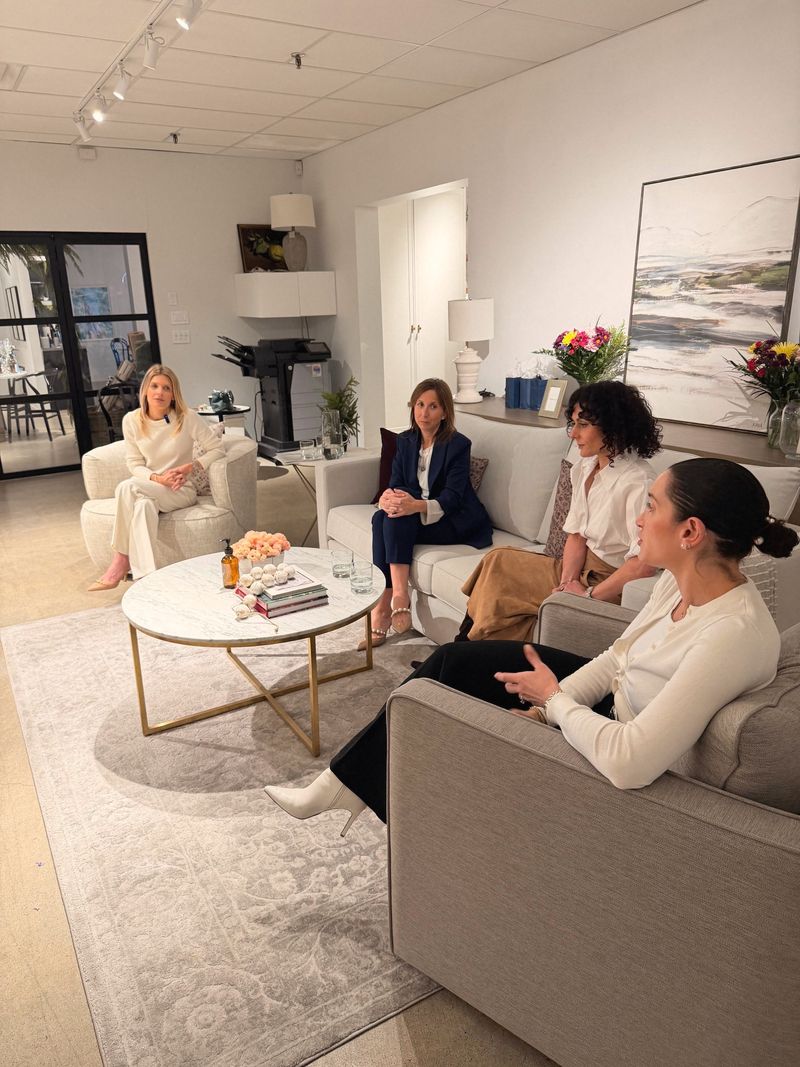 Four physicians in conversation on sofas