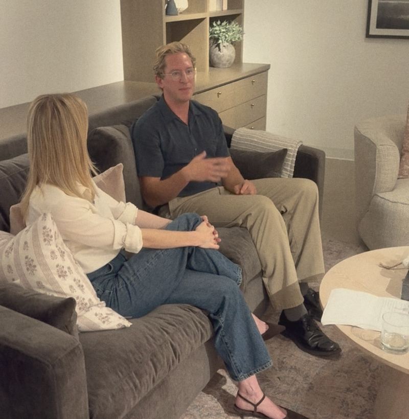 Dr. Say Kerner in conversation with a guest doctor on a dark sofa